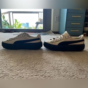 Cream platform pumas with navy sole and gold details